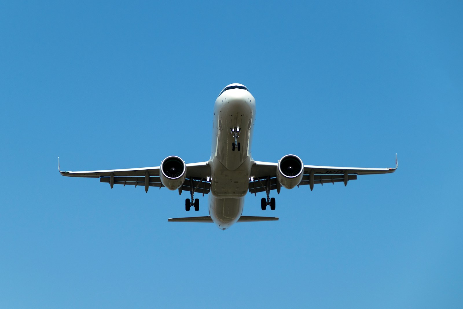 a large jetliner flying through a blue sky